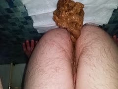 Hairy ass releasing a pile of poop